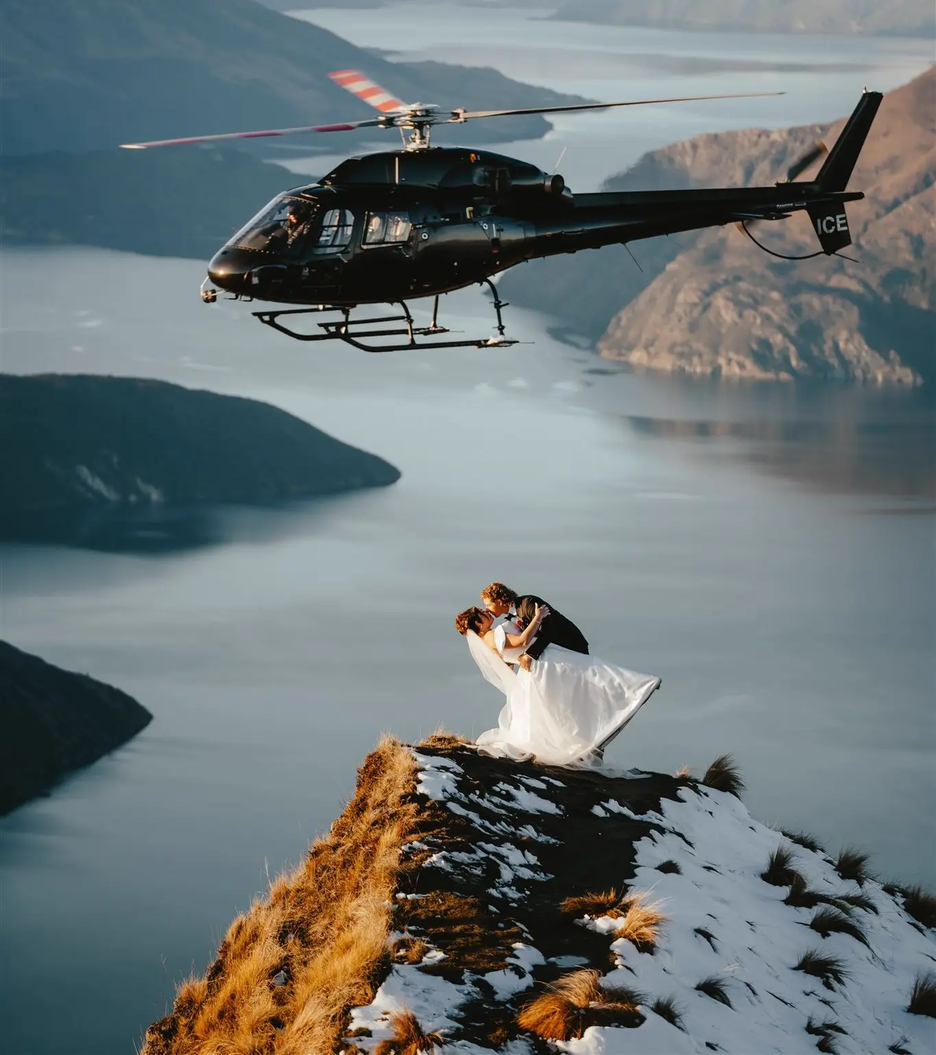 Couple kissing at Coromandel Peak with helicopter flyby, Wanaka