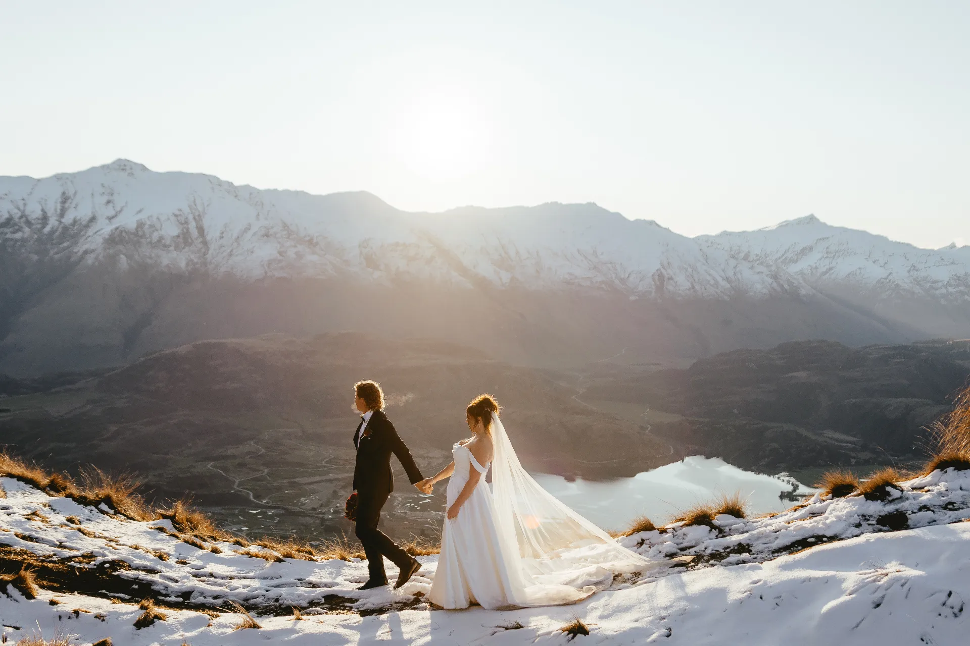 Couple walking a mountain ridge at sunset, Wanaka