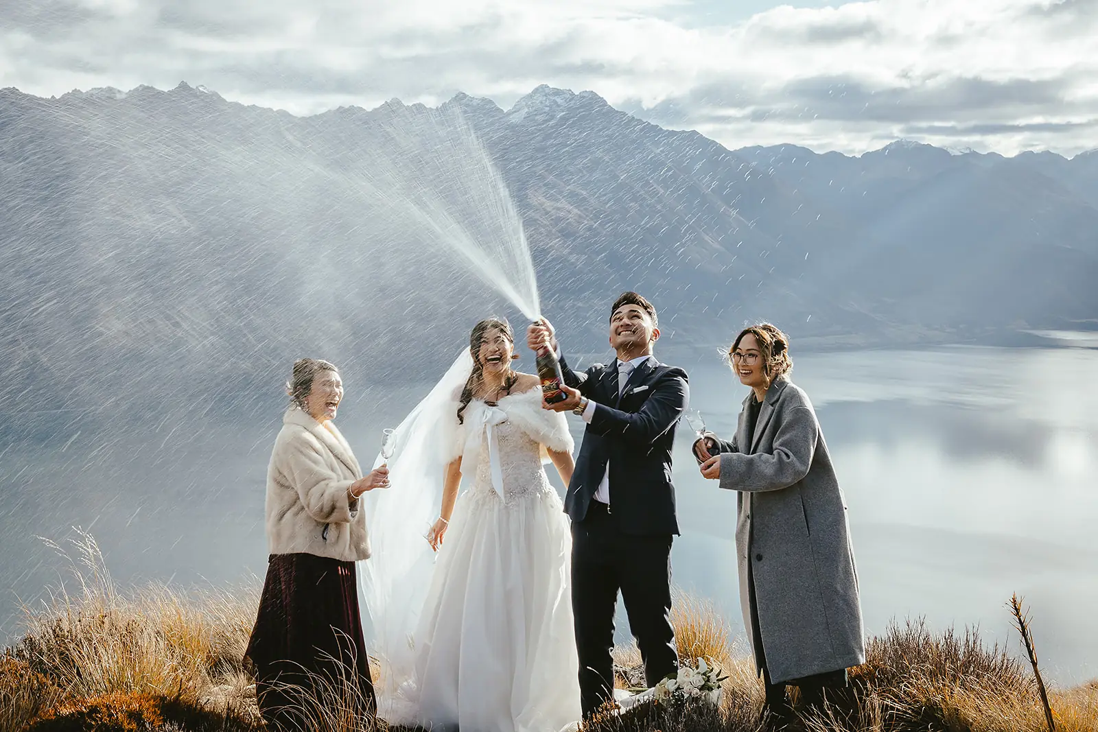 Wedding party champagne celebration on a Queenstown mountain summit